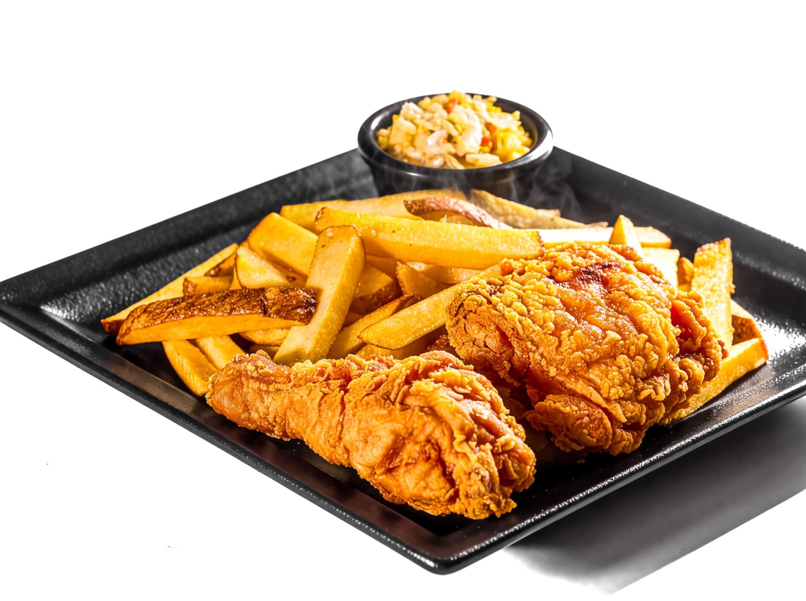 Delicious fried chicken served with crispy fries and coleslaw, ideal for comfort food lovers.